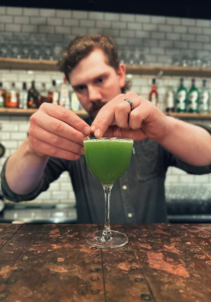 Bartender garnishing a cocktail at the kröns bar on Laugavegur